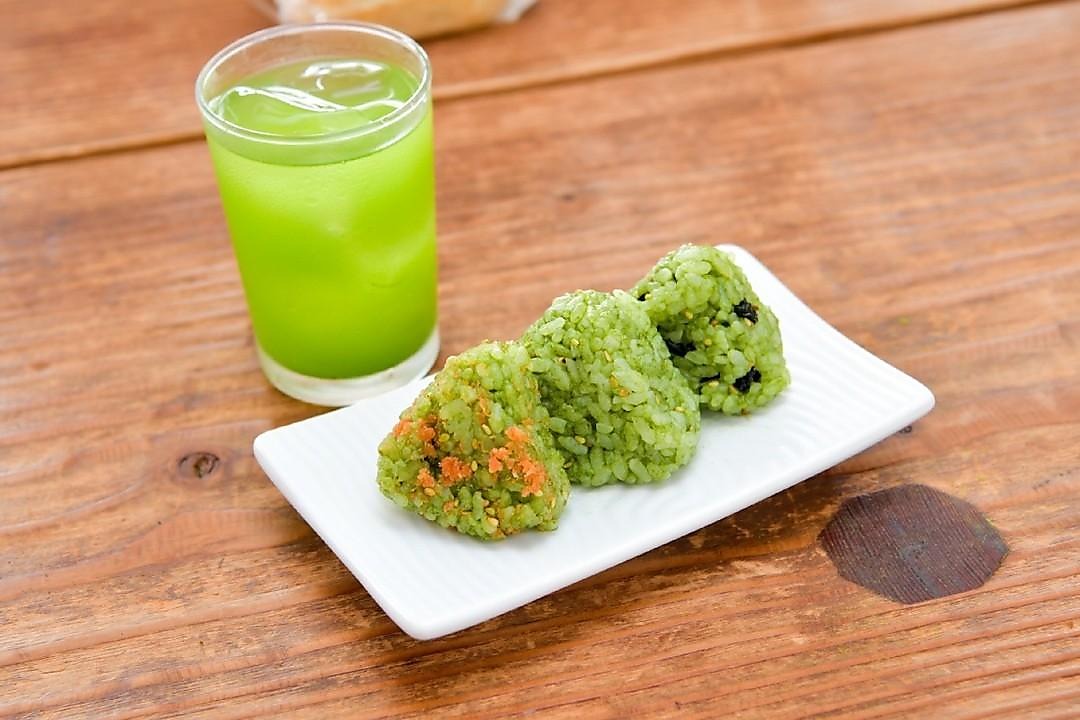 Green mulberry onigiri rice balls alongside an iced Kuwa Matcha drink